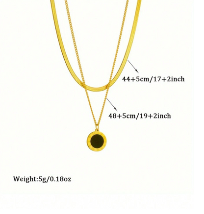 Gold necklace with a pendant, showing measurements and weight on a white background