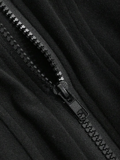 A woman wearing a black ribbed trim zip-up sweatshirt jacket with a high mock neck paired with light grey sweatpants