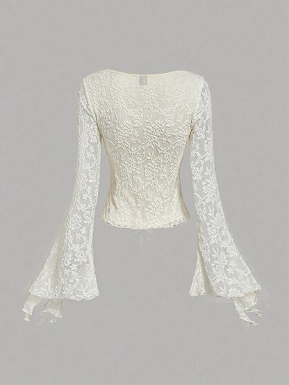 Apricot sheer floral lace tie-front long flare sleeve top laid flat against a neutral background