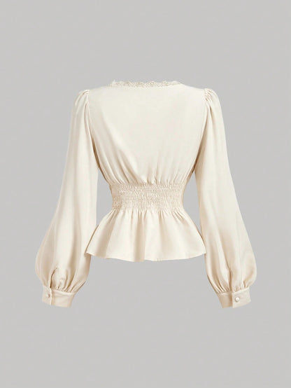 Apricot striped long-sleeve peplum blouse with a lace-trim V-neck, button-front closure, and lantern sleeves against a neutral background.