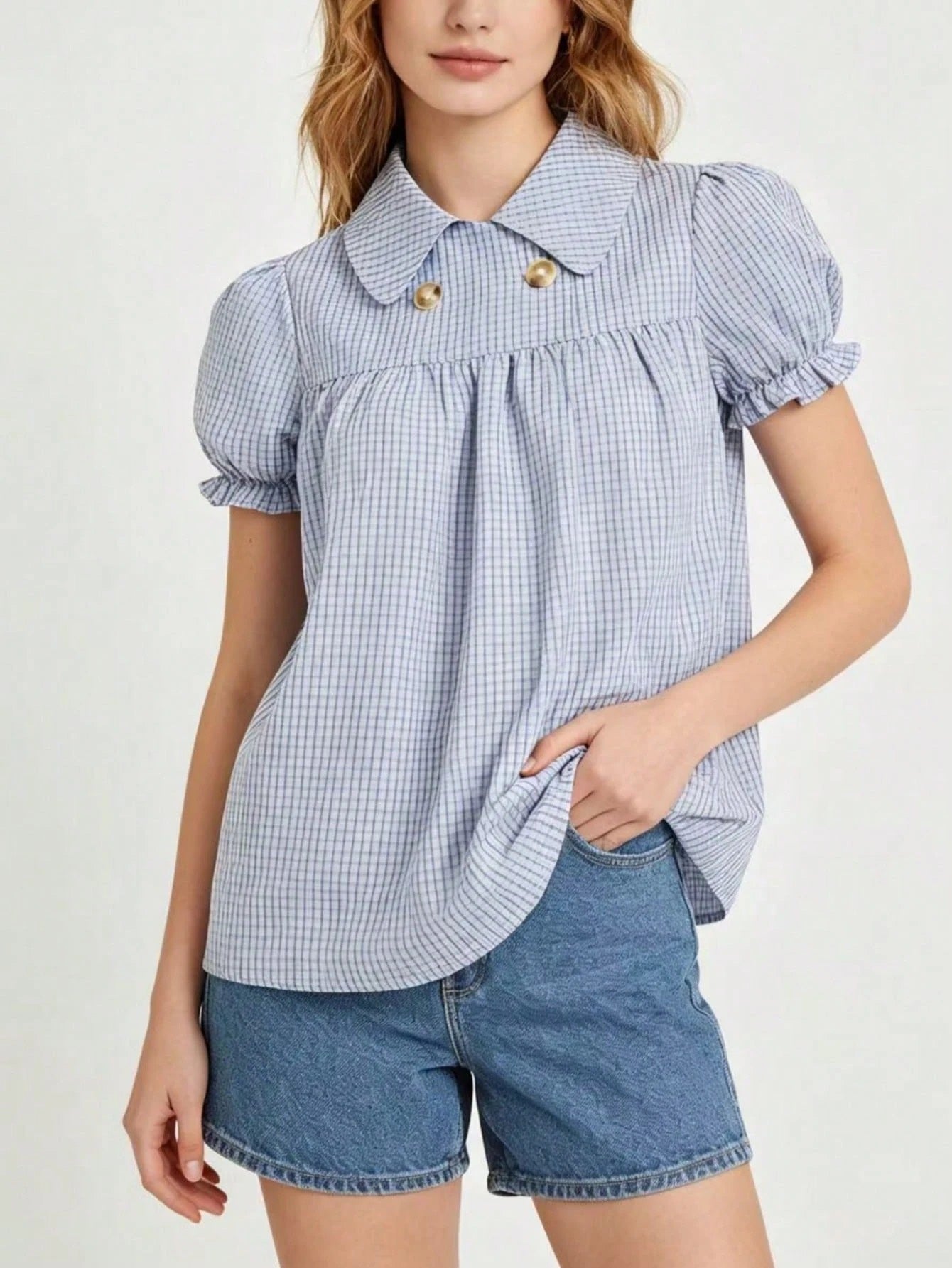 Blue and white gingham plaid short puff sleeve collared shirt with double front buttons laid flat