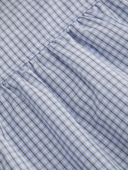 Blue and white gingham plaid short puff sleeve collared shirt with double front buttons laid flat