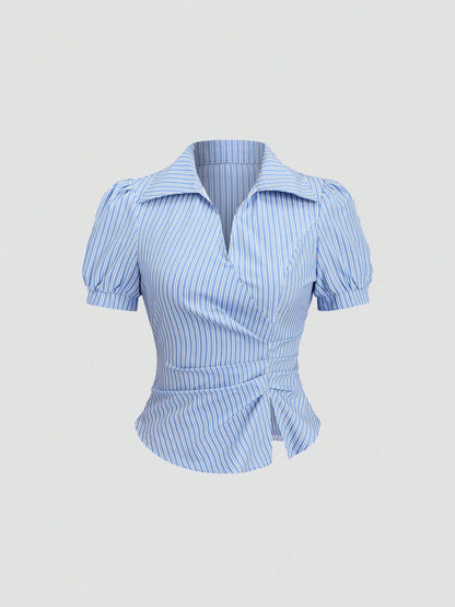 Blue and white striped short-sleeve polo collar peplum blouse with a wrap-effect ruched waist laid flat against a neutral background