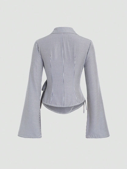 Blue and white striped wrap blouse with a collar, waist bow tie, and long flare sleeves laid flat against a neutral background