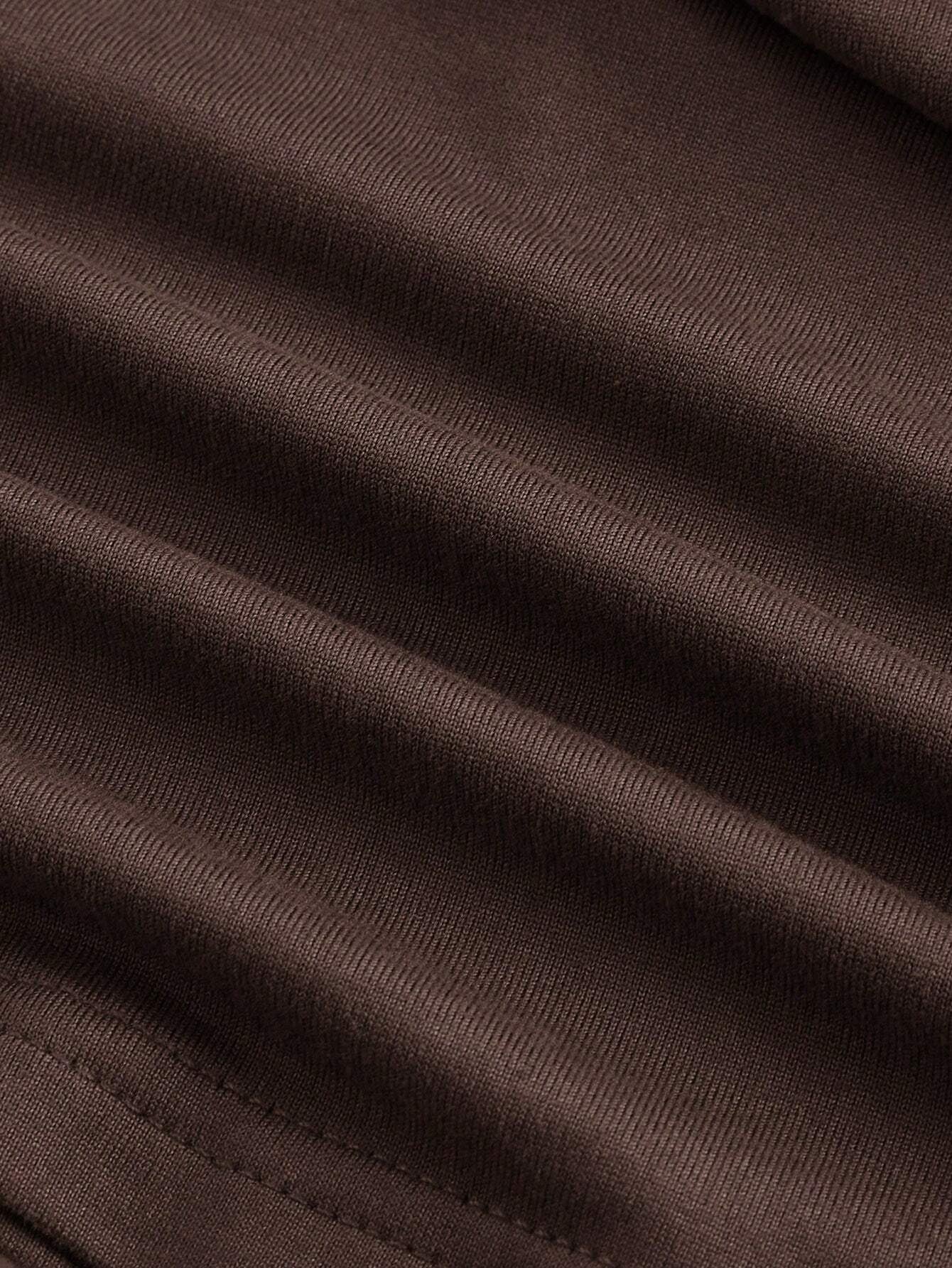 Brown asymmetric neckline ruched long flare sleeve top laid flat against a neutral background