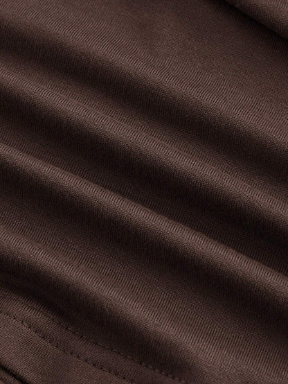 Brown asymmetric neckline ruched long flare sleeve top laid flat against a neutral background
