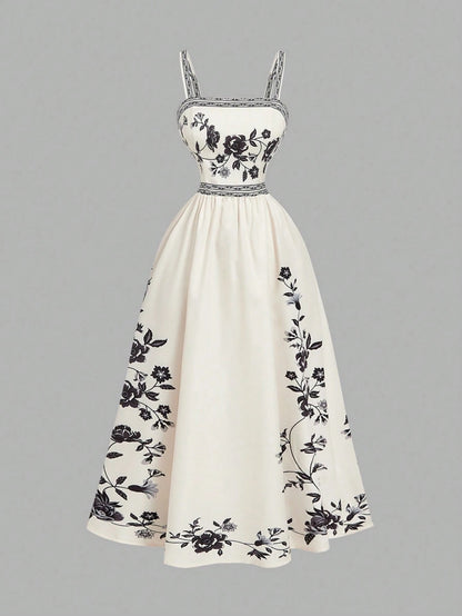 Elegant white A-line midi dress with black and white floral border print and spaghetti straps
