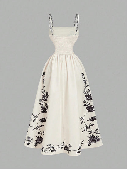 Elegant white A-line midi dress with black and white floral border print and spaghetti straps1