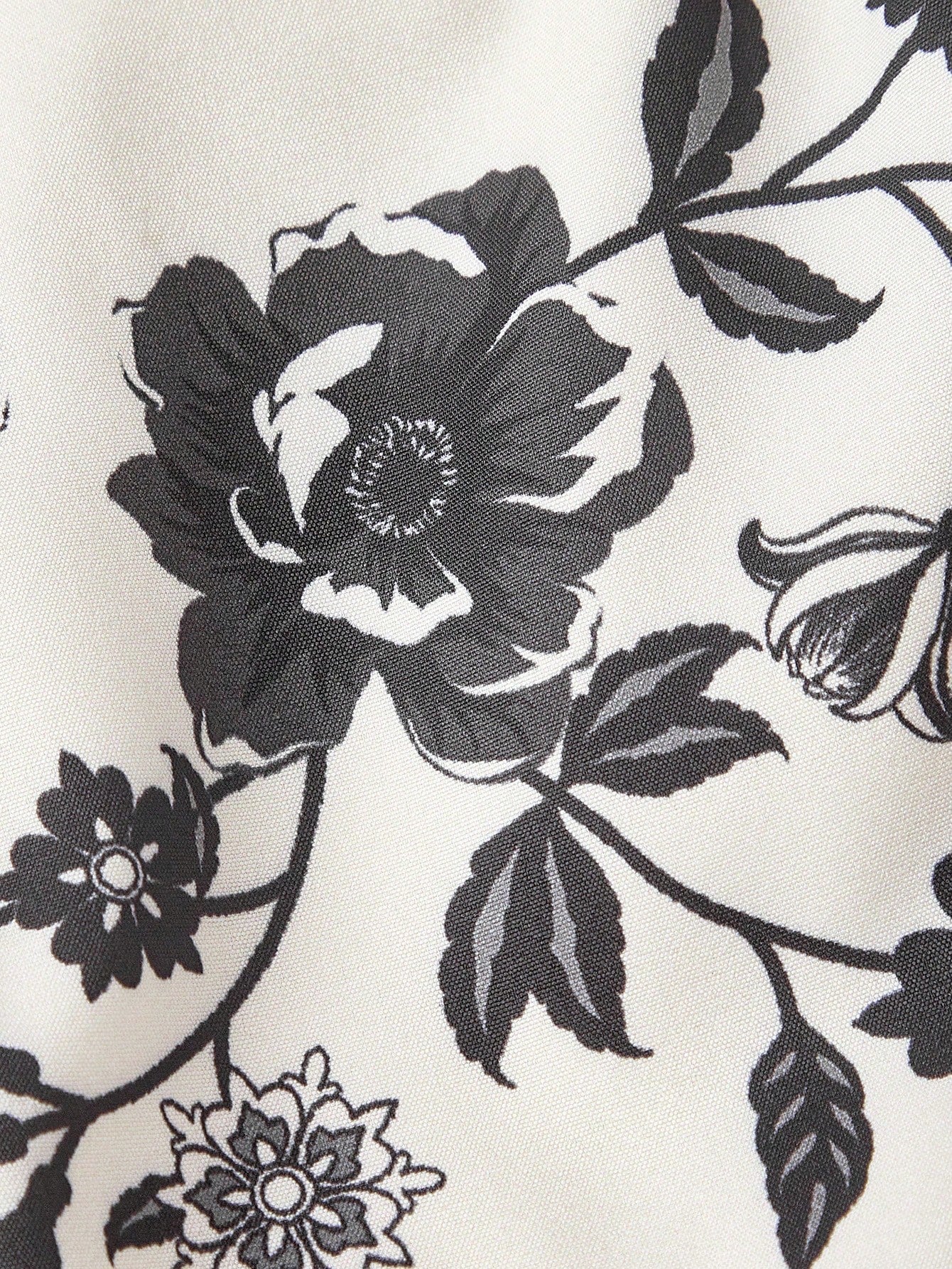 Elegant white A-line midi dress with black and white floral border print and spaghetti straps2