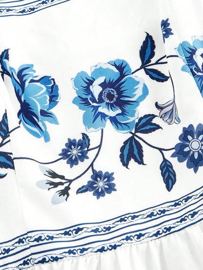Elegant white A-line midi dress with blue floral border print and spaghetti straps2