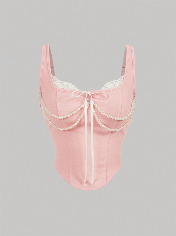 Pink lace lingerie with pearl details on a gray background