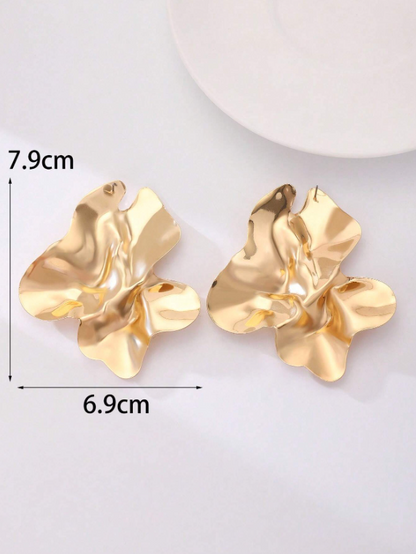 Gold earrings with measurements on a white background