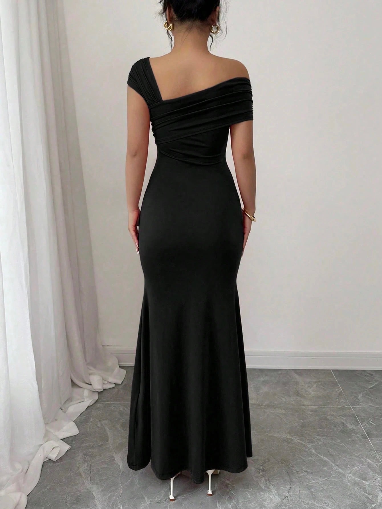 Fashzeo black asymmetrical beaded mermaid long dress featuring a sleek one-shoulder neckline and floor-length evening gown silhouette