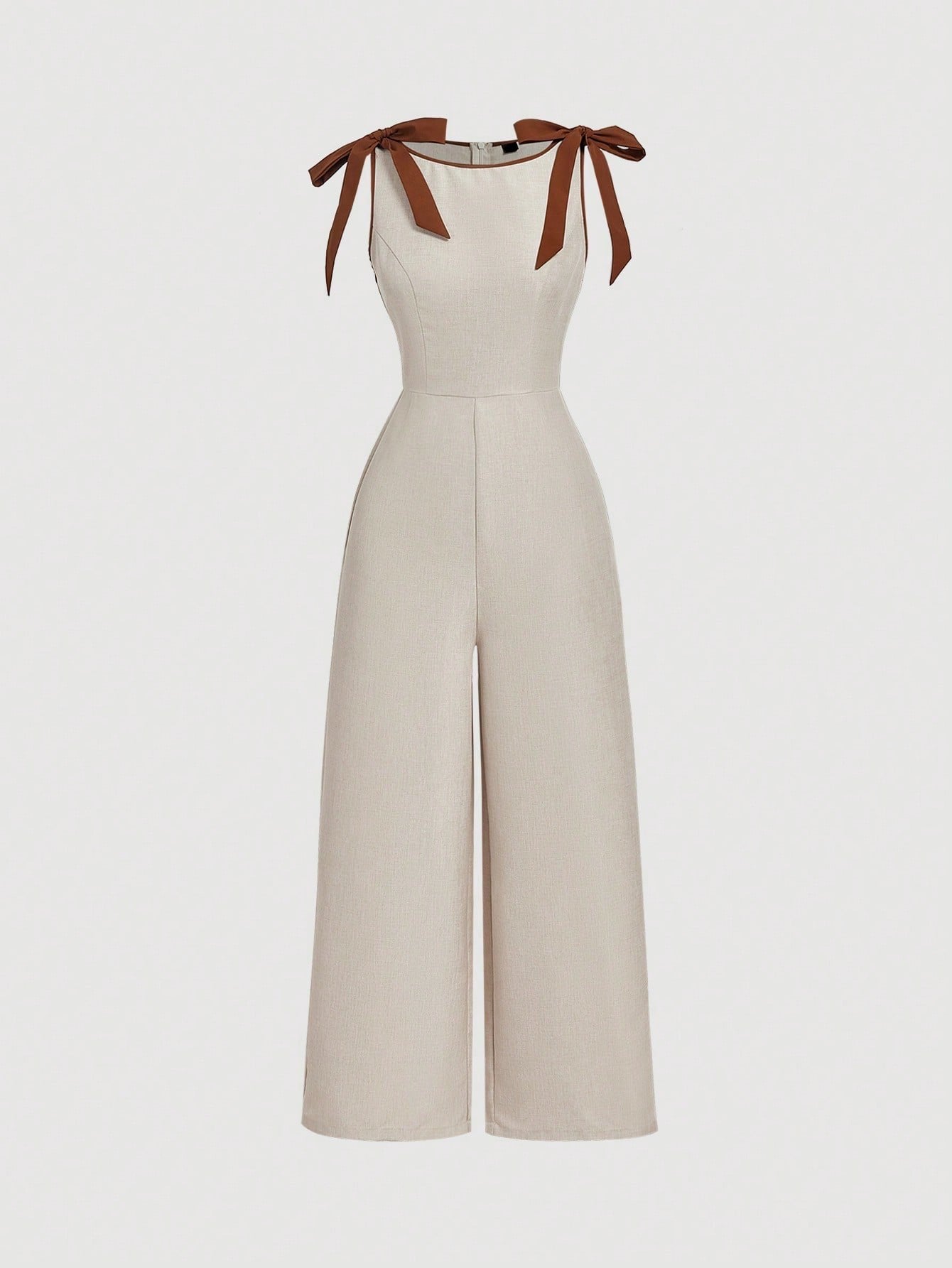 Khaki wide-leg sleeveless jumpsuit featuring contrast brown shoulder bow ties and trim laid flat against a neutral background