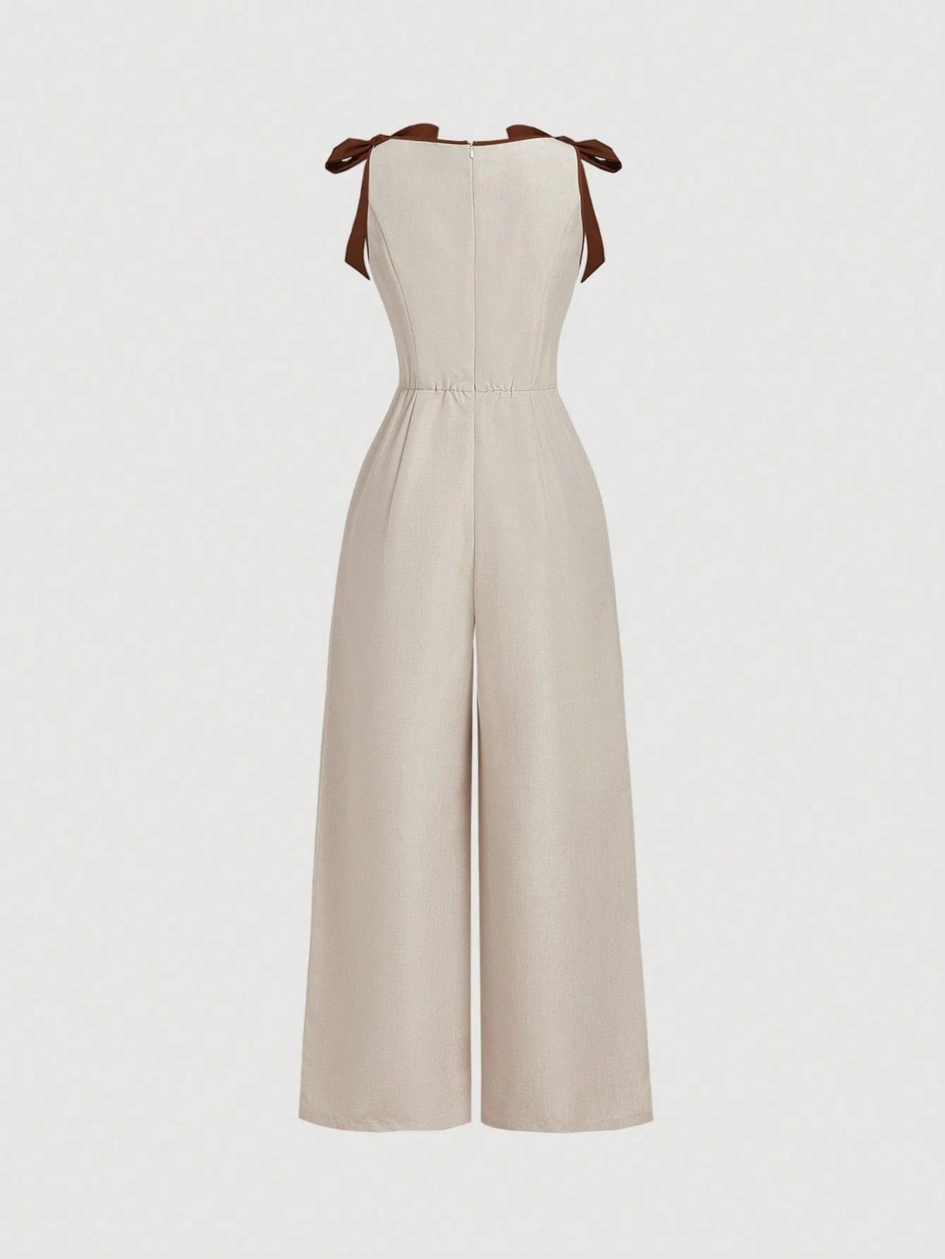 Khaki wide-leg sleeveless jumpsuit featuring contrast brown shoulder bow ties and trim laid flat against a neutral background