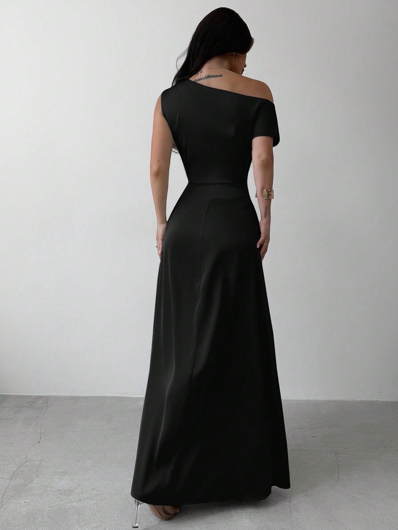 Model wearing the Fashzeo black satin one-shoulder maxi gown with ruched detailing