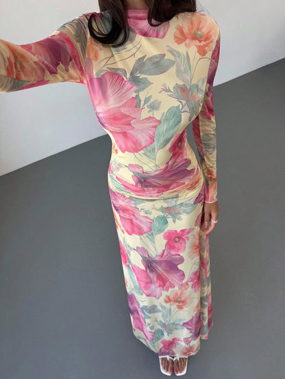 Model wearing the Fashzeo floral mesh long-sleeve maxi dress in apricot multicolor.