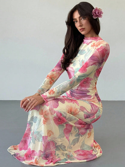 Model wearing the Fashzeo floral mesh long-sleeve maxi dress in apricot multicolor.