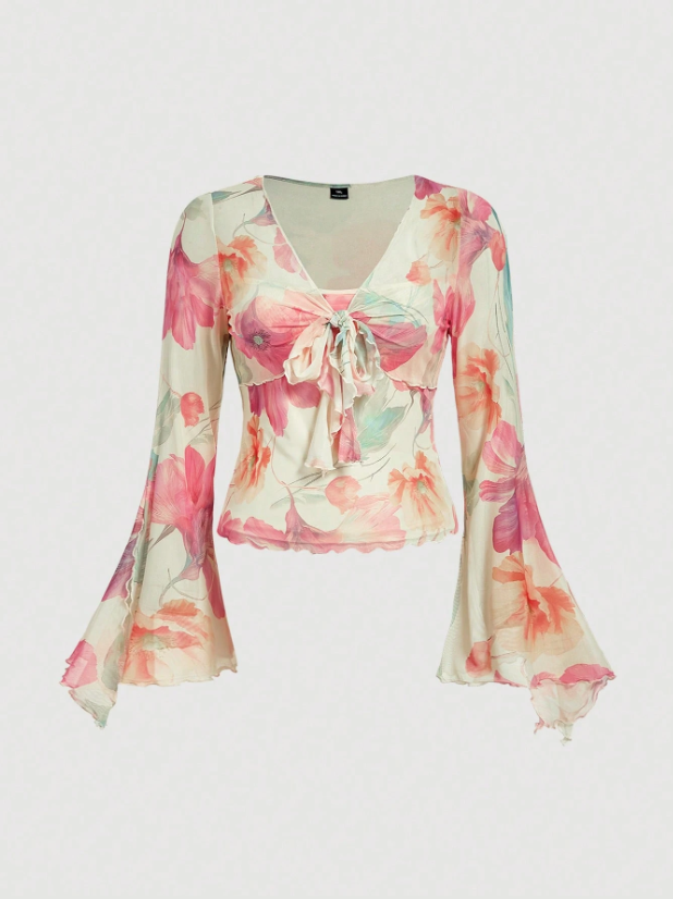 Pink and green floral print long-sleeve flare blouse with a V-neck and twist-front tie detail laid flat against a neutral background