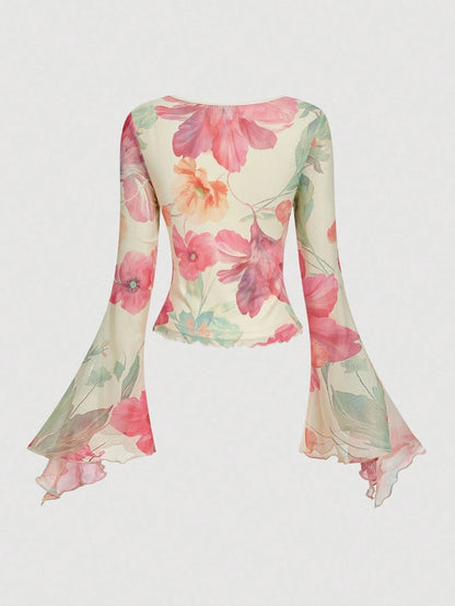 Pink and green floral print long-sleeve flare blouse with a V-neck and twist-front tie detail laid flat against a neutral background
