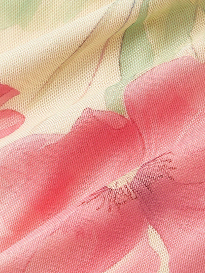 Pink and green floral print long-sleeve flare blouse with a V-neck and twist-front tie detail laid flat against a neutral background