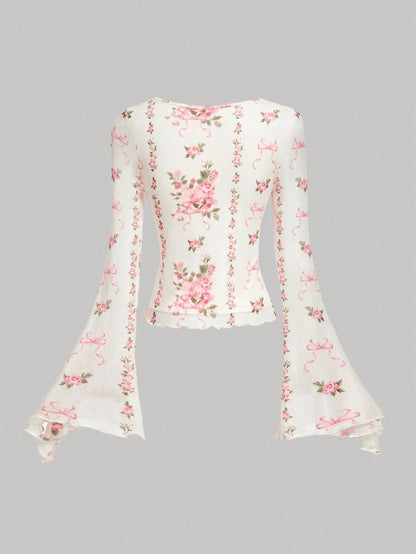 Pink and white floral print tie-front flare sleeve top laid flat against a neutral background