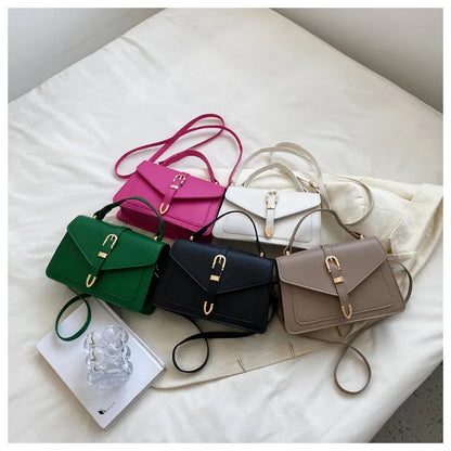 Collection of colorful handbags on a white surface