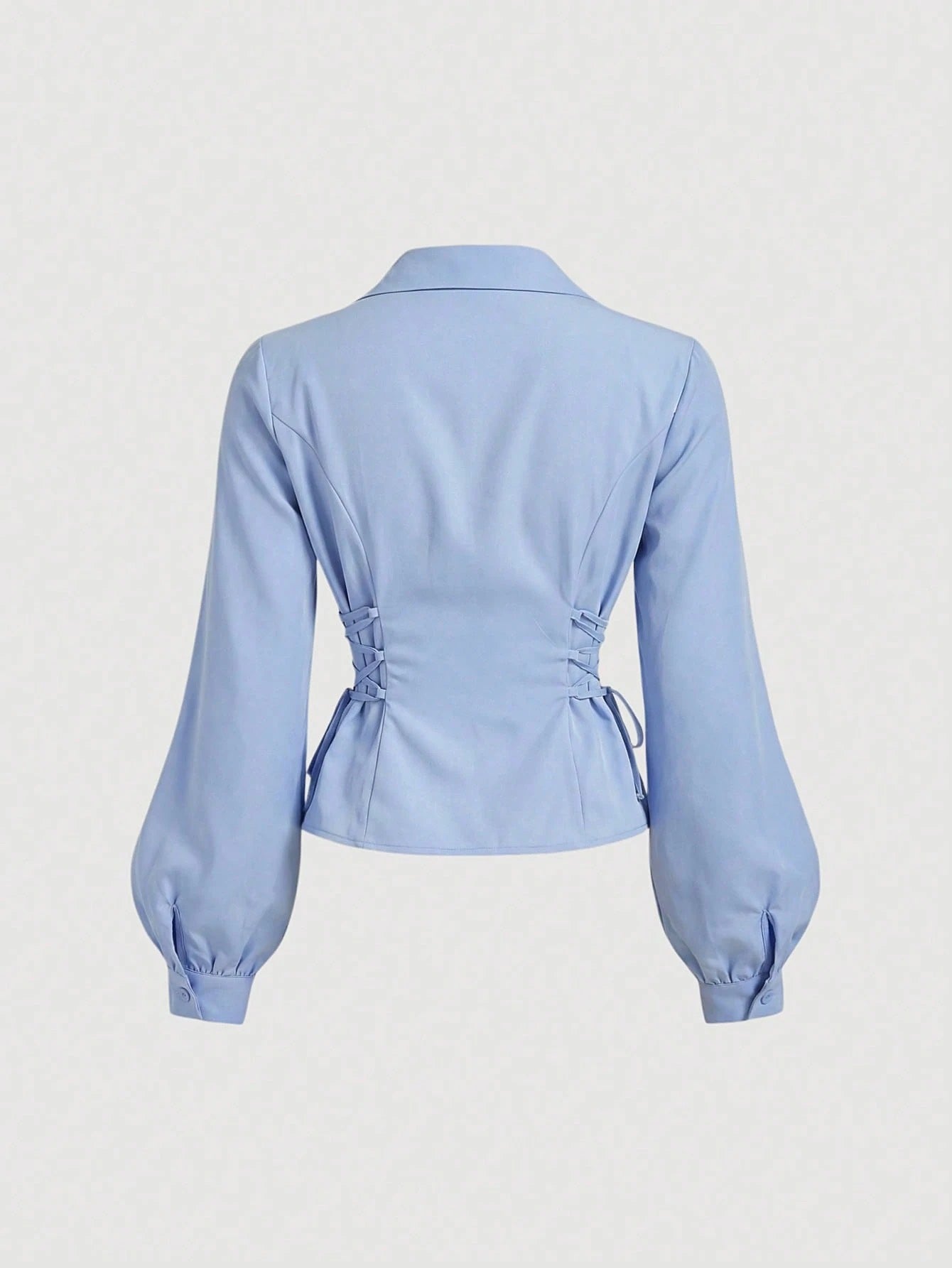 Solid color blue button-down shirt with lapel collar, lantern sleeves, and waist lace-up corset ties laid flat