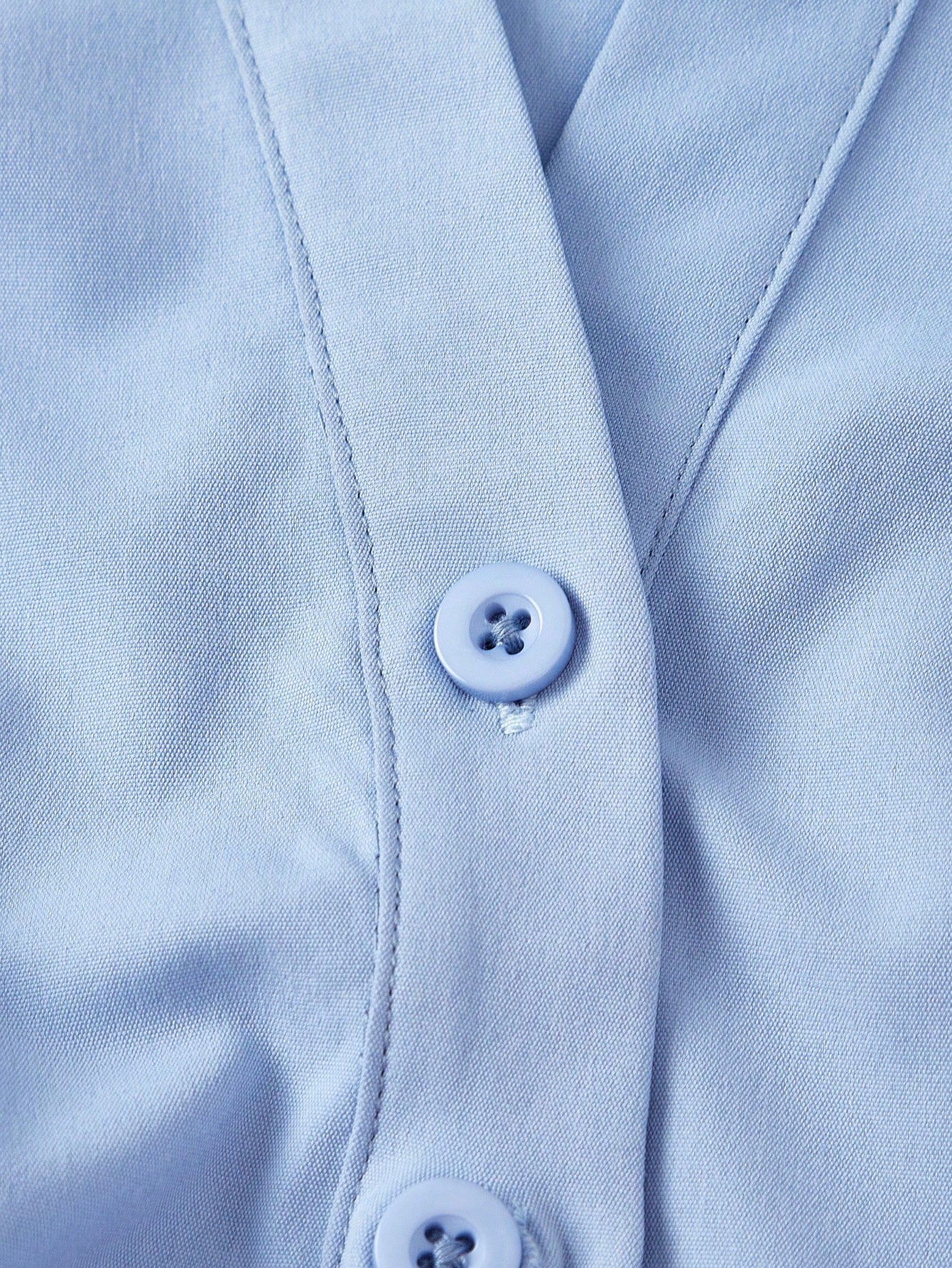 Solid color blue button-down shirt with lapel collar, lantern sleeves, and waist lace-up corset ties laid flat