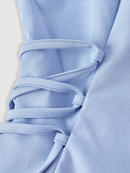 Solid color blue button-down shirt with lapel collar, lantern sleeves, and waist lace-up corset ties laid flat