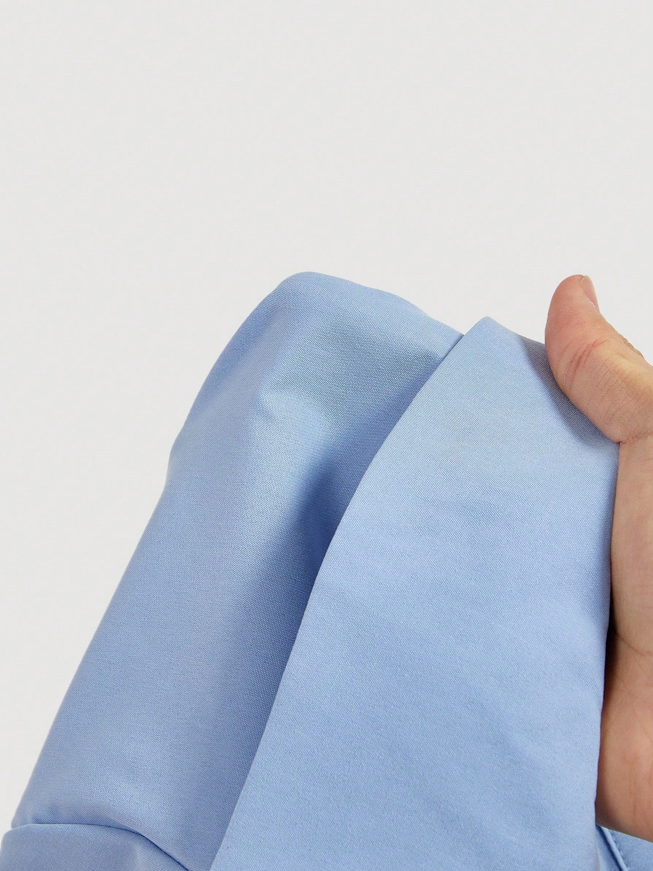 Solid color blue button-down shirt with lapel collar, lantern sleeves, and waist lace-up corset ties laid flat