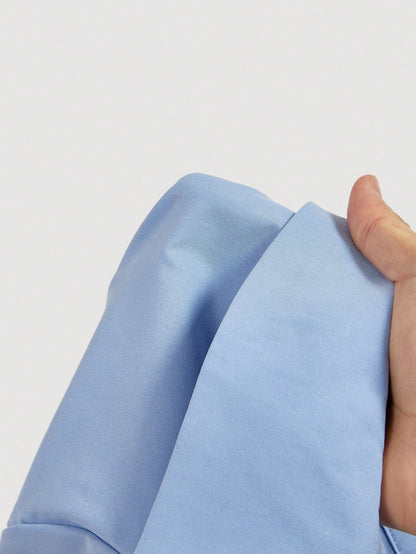 Solid color blue button-down shirt with lapel collar, lantern sleeves, and waist lace-up corset ties laid flat