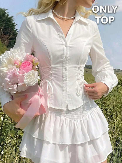 Solid color white button-down shirt with lapel collar, lantern sleeves, and waist lace-up corset ties laid flat