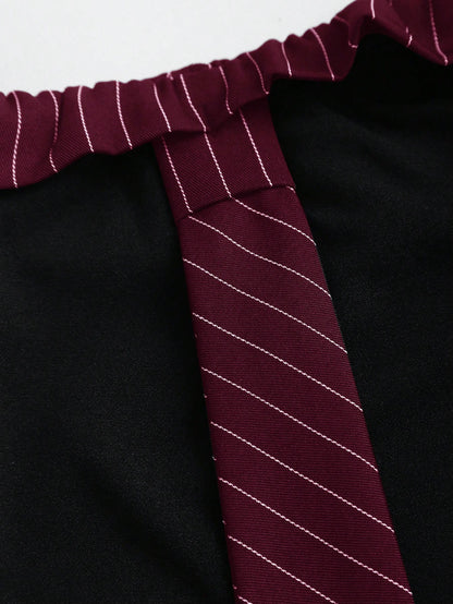 Two-tone off-shoulder black top with striped maroon sleeves and an attached necktie detail laid flat against a neutral background