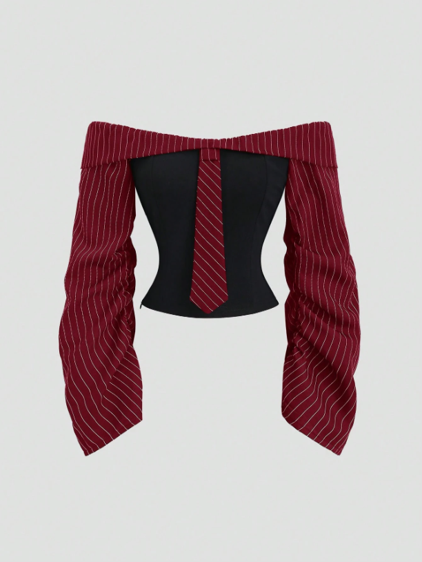 Two-tone off-shoulder black top with striped red sleeves and an attached necktie detail laid flat against a neutral background