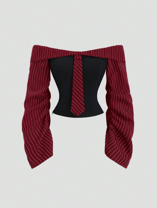 Two-tone off-shoulder black top with striped red sleeves and an attached necktie detail laid flat against a neutral background