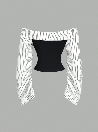Two-tone off-shoulder black top with striped white sleeves and an attached necktie detail laid flat against a neutral background