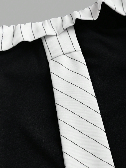 Two-tone off-shoulder black top with striped white sleeves and an attached necktie detail laid flat against a neutral background