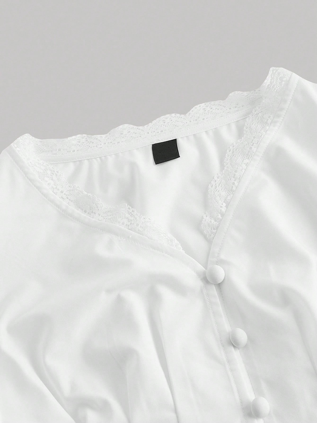 White striped long-sleeve peplum blouse with a lace-trim V-neck, button-front closure, and lantern sleeves against a neutral background.