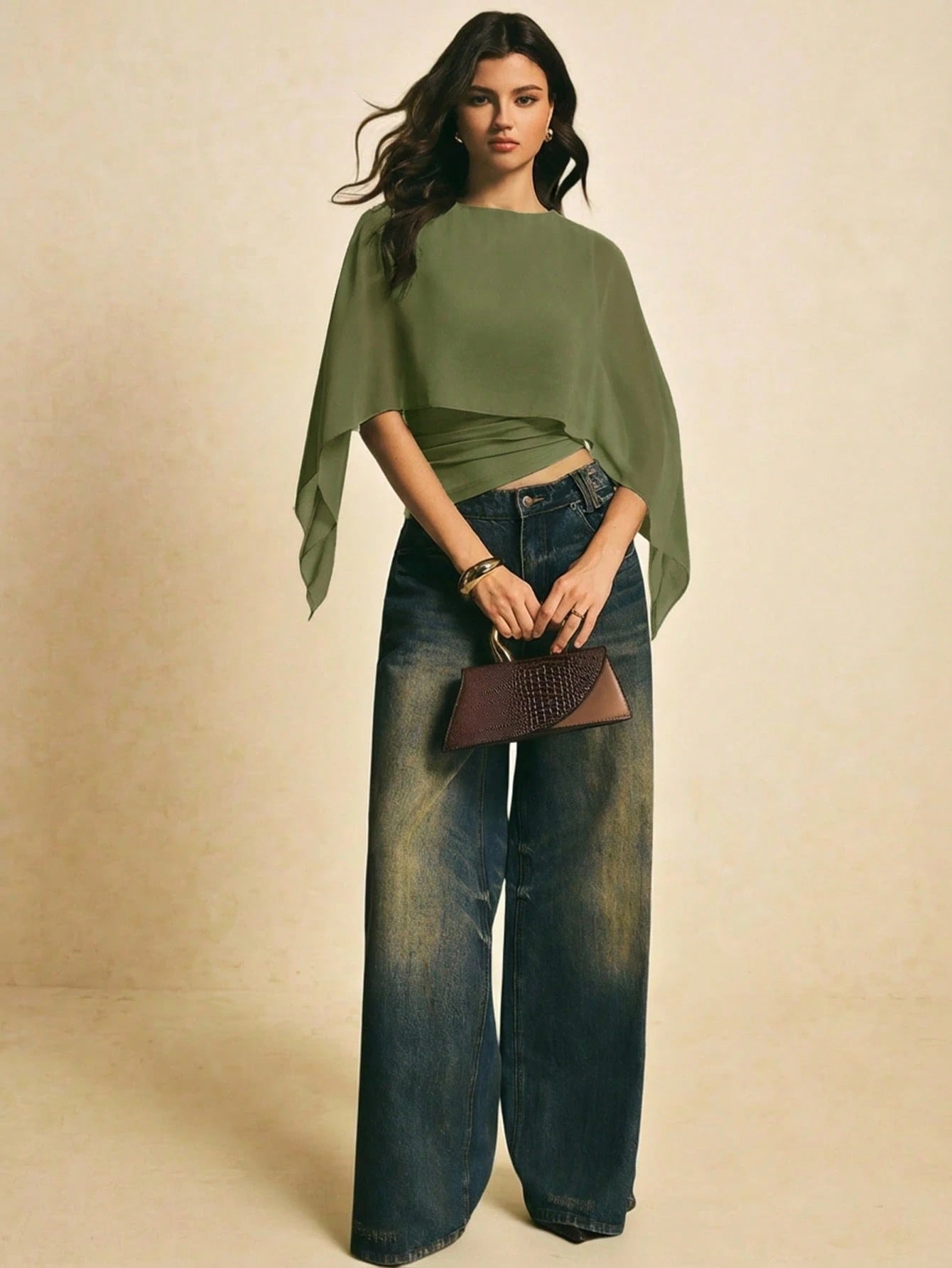 Woman wearing a Army Green solid color elegant shawl blouse with cape sleeves paired with dark denim jeans