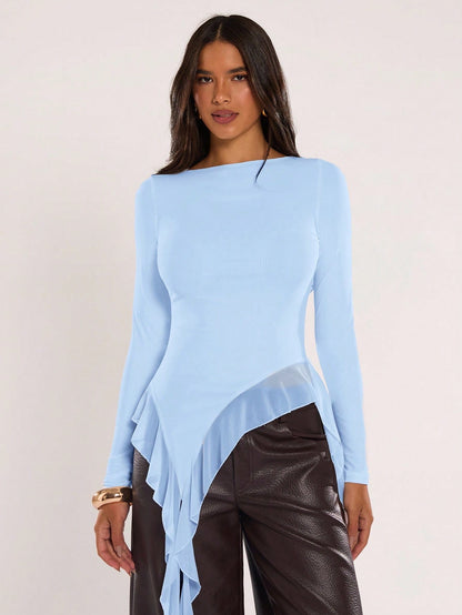 Woman wearing an baby blue fitted long sleeve top with an asymmetric ruffle hem paired with dark brown faux leather pants