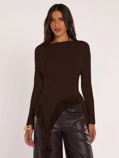 Woman wearing an coffee brown fitted long sleeve top with an asymmetric ruffle hem paired with dark brown faux leather pants