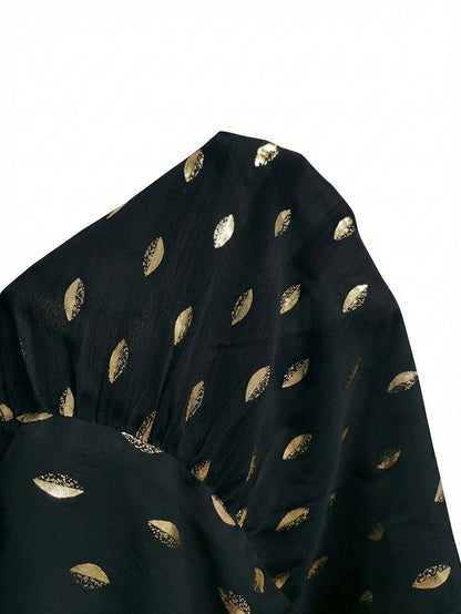 Women's black long-sleeve chiffon blouse with metallic foil dots, a V-neck, a scarf tie, and a tiered ruffled hem paired with blue jeans.