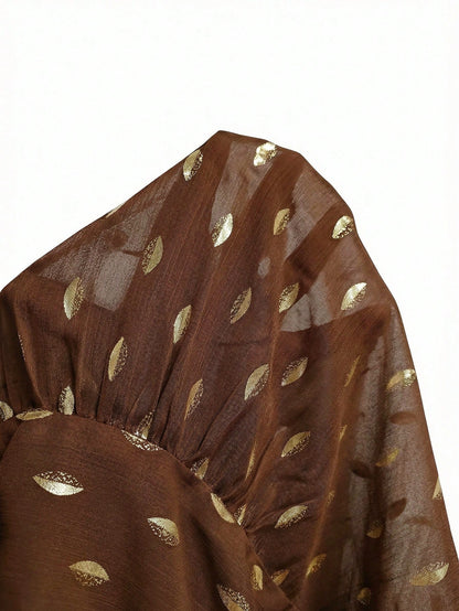 Women's brown long-sleeve chiffon blouse with metallic foil dots, a V-neck, a scarf tie, and a tiered ruffled hem paired with blue jeans.