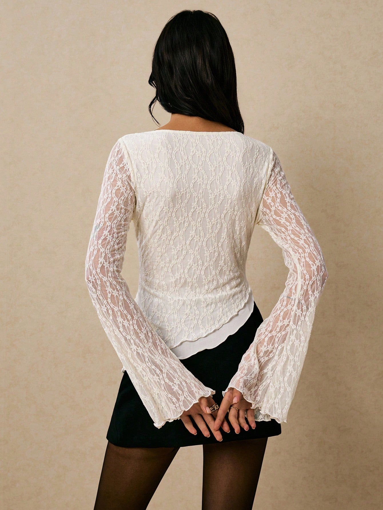 Women's elegant lace flare sleeve asymmetric top in white, brown, red violet, and black paired with a black skirt for a trendy Gen Z look.