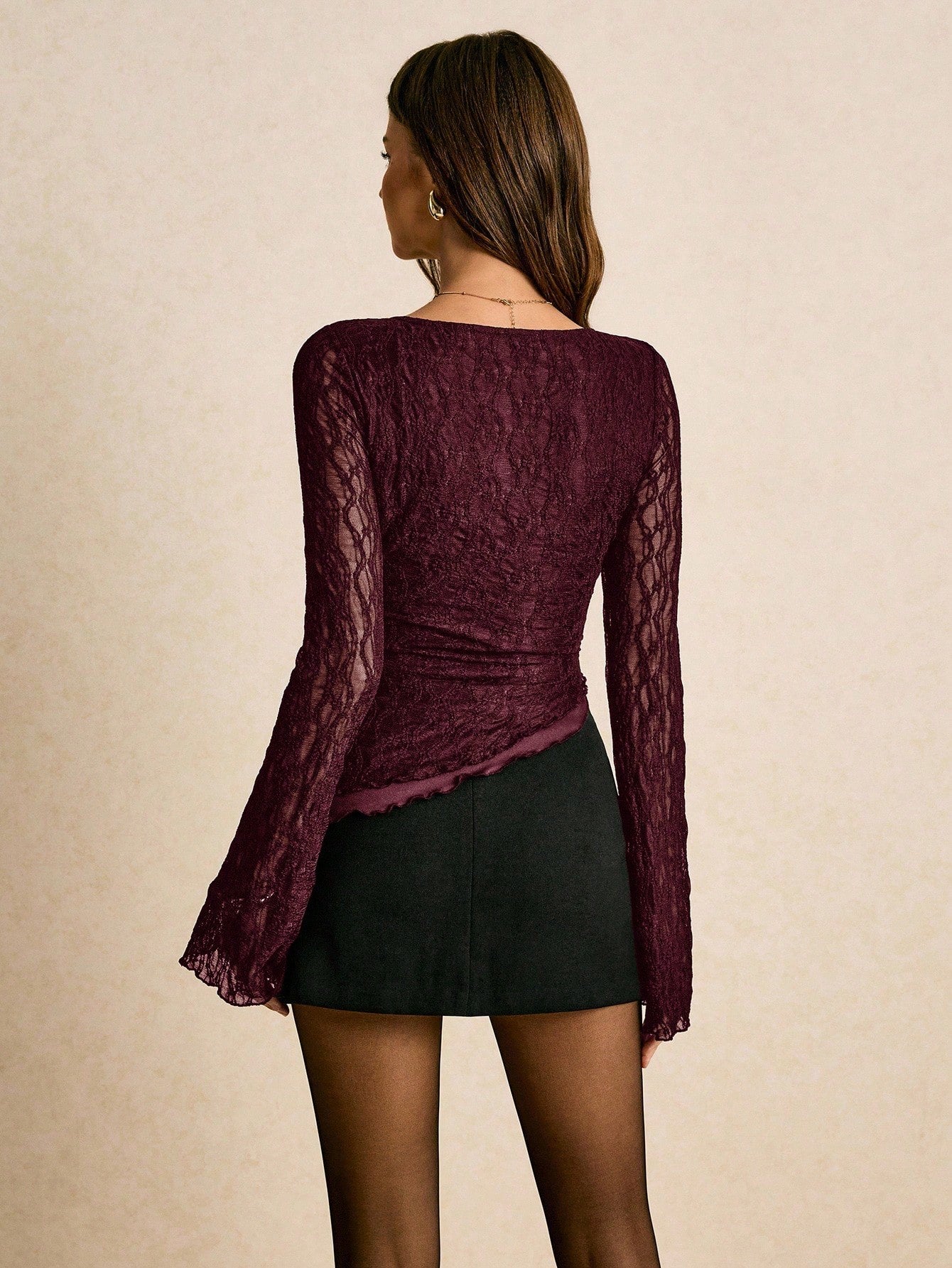 Women's elegant lace flare sleeve asymmetric top in white, brown, red violet, and black paired with a black skirt for a trendy Gen Z look.
