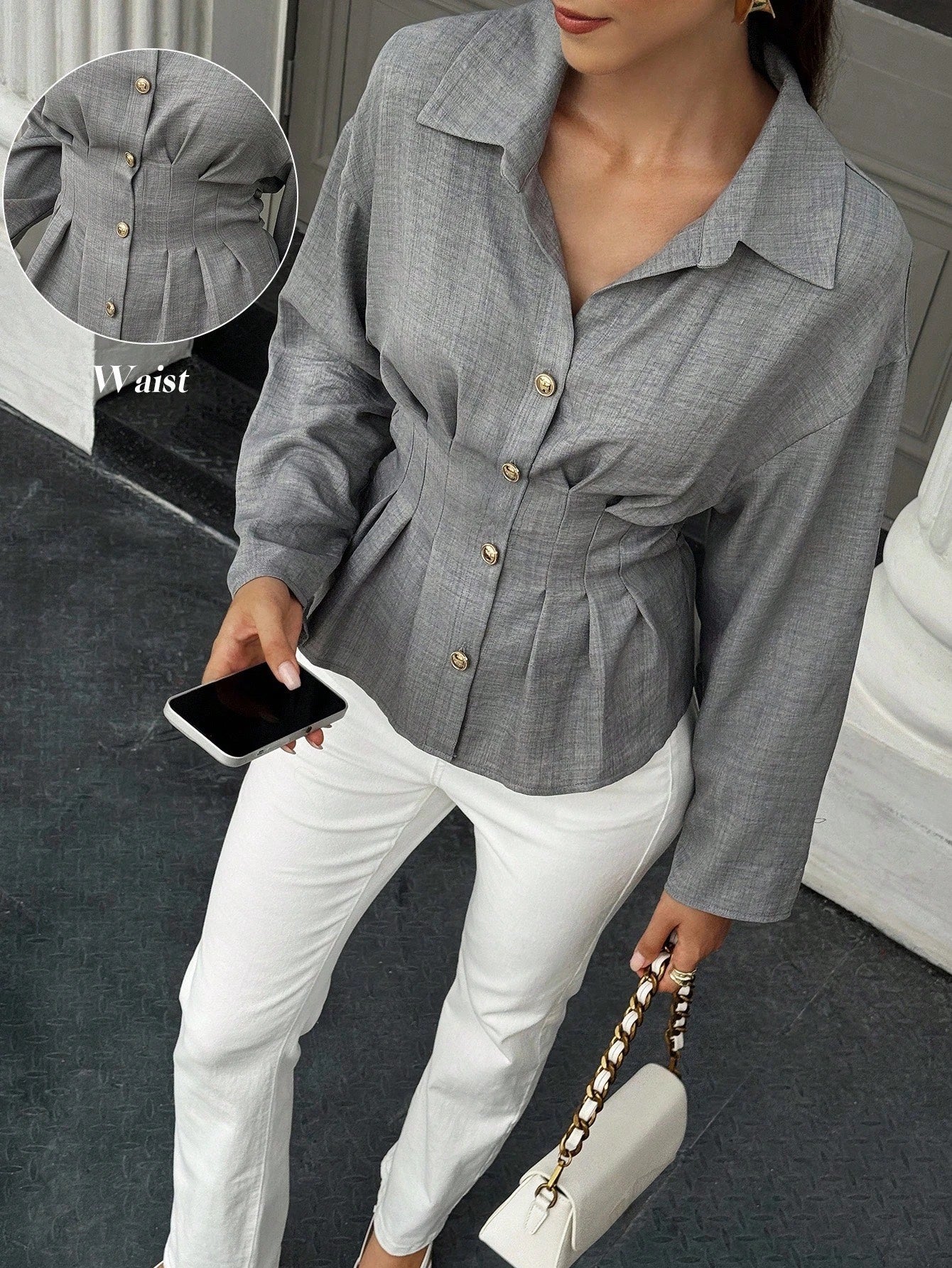 Women's grey long-sleeve pleated waist shirt with a lapel collar paired with white pants for an elegant office look.