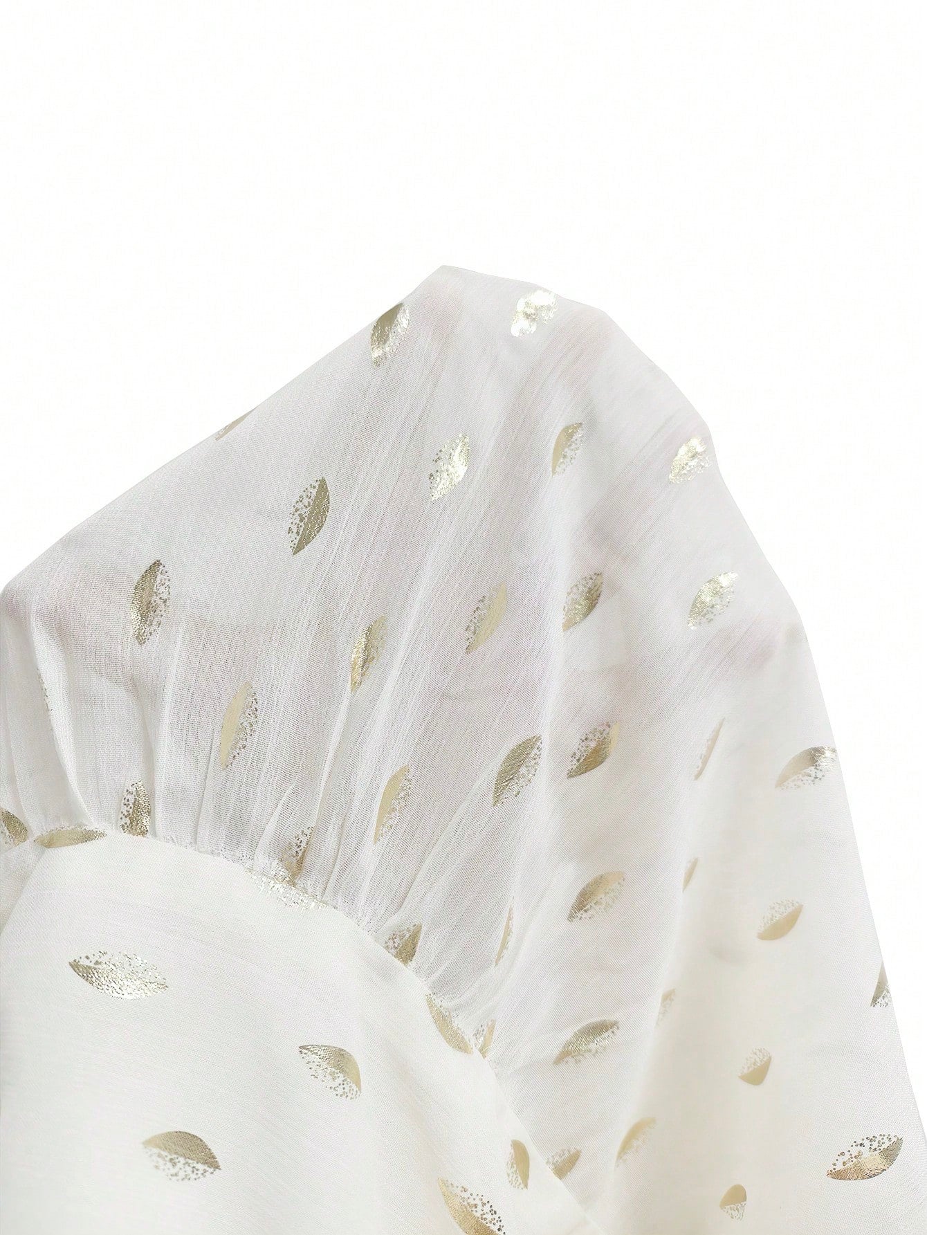 Women's white long-sleeve chiffon blouse with metallic foil dots, a V-neck, a scarf tie, and a tiered ruffled hem paired with blue jeans.