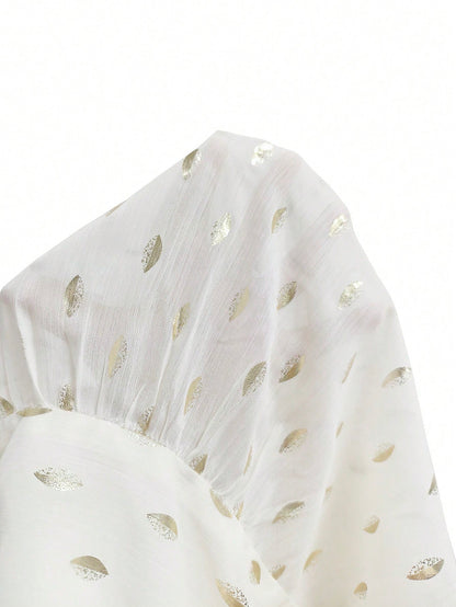 Women's white long-sleeve chiffon blouse with metallic foil dots, a V-neck, a scarf tie, and a tiered ruffled hem paired with blue jeans.