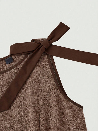 brown wide-leg sleeveless jumpsuit featuring contrast brown shoulder bow ties and trim laid flat against a neutral background